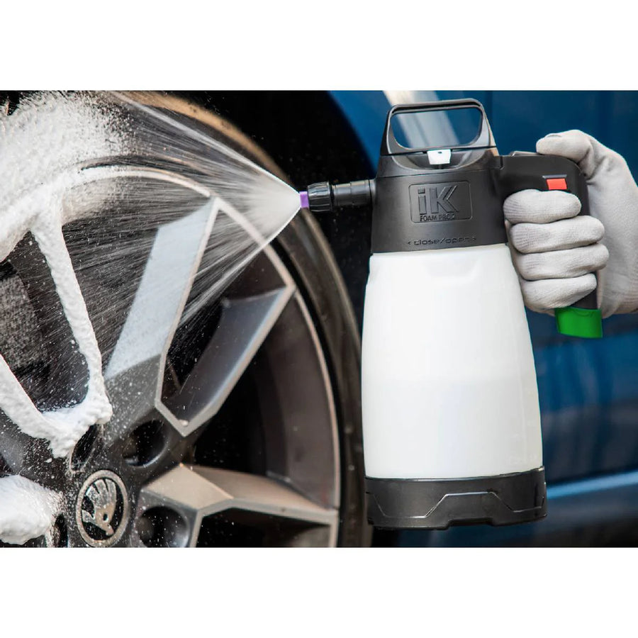 En håndsprøyte spruter skum på et bilhjul med IK SPRAYERS Foam Pro 2 lavtrykkskanne på 1,9 liter.